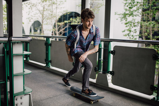 Young man riding a skate downtown