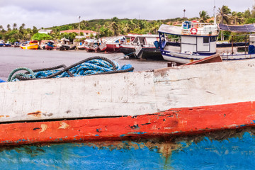 Fototapeta na wymiar Boats moored at the beach, prepared for maintenance, before fishing.