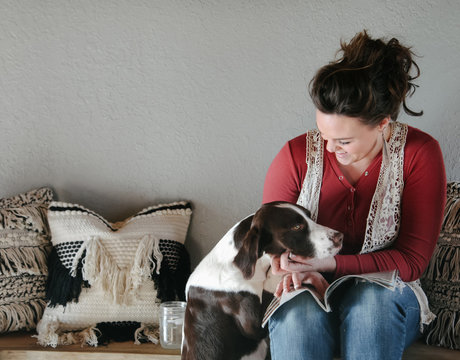woman gives her dot attention while relaxing