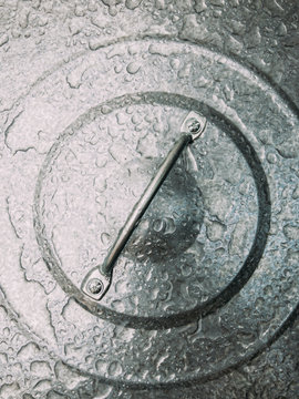 Raindrops on trash can lid