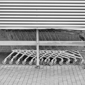 Row of shopping carts outside a mall