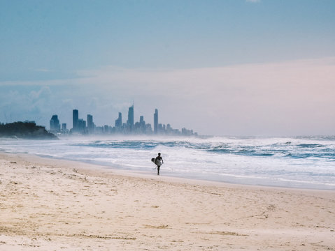 Surfer walking on the beach.