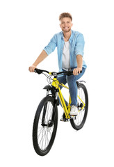 Fototapeta na wymiar Handsome young man riding bicycle on white background