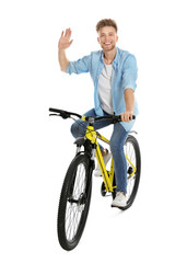 Fototapeta na wymiar Handsome young man riding bicycle on white background