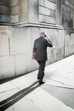 A city worker walks along a street