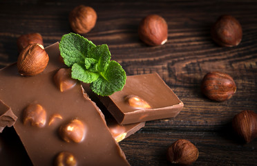 chocolate with nuts on a wooden background