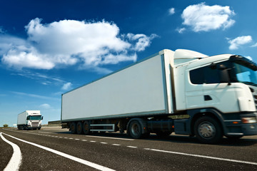 White truck is on highway - business, commercial, cargo transportation concept