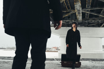 Woman come out from suitcase to man