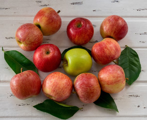 Raw red and green apples on white wooden table, top view. Flat lay, from above.