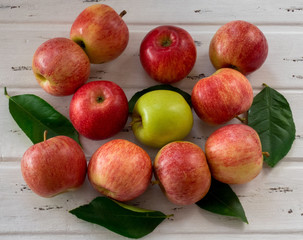 Raw red and green apples on white wooden table, top view. Flat lay, from above.