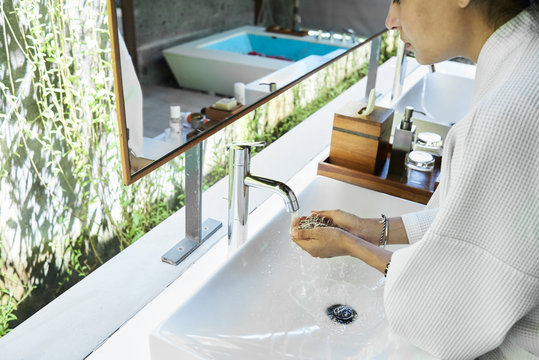 Woman hands with water for cleaning face. Wake up.