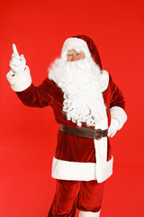 Fototapeta na wymiar Happy authentic Santa Claus on red background
