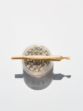Marijuana inside a grinder and rolled joint