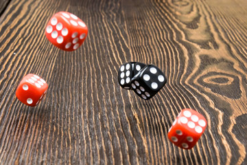 Playing dice in the game over a wooden table, a game of roulette. The concept of gaming addiction,...