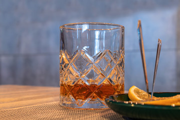 Fototapeta na wymiar A glass of whiskey on the table