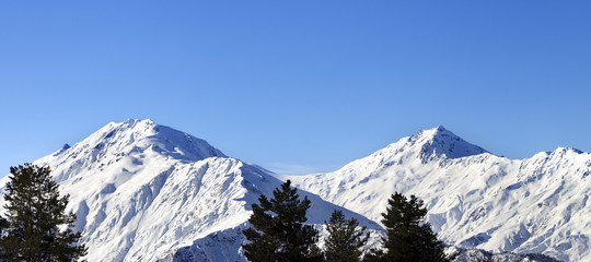 Fototapeta na wymiar Snowy mountains and blue clear sky at nice sun morning