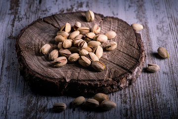 still life of isolated pistachios in the foreground in studio.
