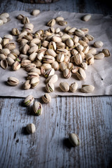 still life of isolated pistachios in the foreground in studio.