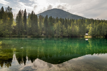 Fototapeta na wymiar Beautiful and colorful Alpine Lake in Nother Italy in cloudy day. Alps region of Italy
