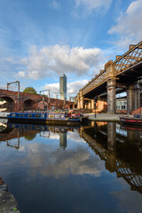 Fototapeta premium Narrowboat on the Bridgewater Canal Castlefield Manchester with the Beetham Tower on the skyline