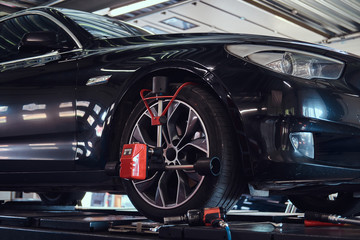 Shiny new car at auto service got a problem with tyres, which will be sorted soon.