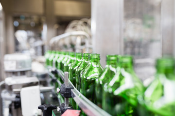 Bottling plant - Water bottling line for processing and bottling pure spring water into small bottles. Selective focus.