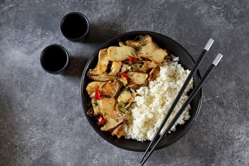 Fried oyster mushrooms with chili pepper, garlic and soy sauce with boiled rice. Healthy food.