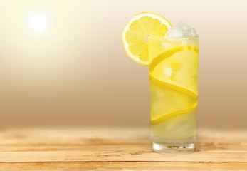 Lemonade with fresh lemon on desk