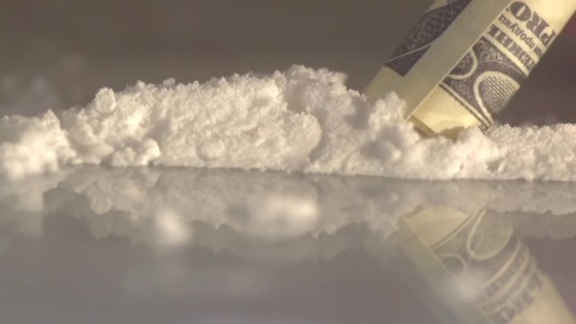 one hundred dollar tube with white powder, slow motion, drugs