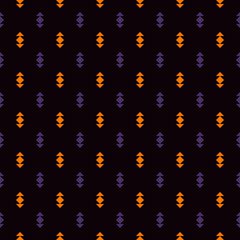 Fototapeta na wymiar Seamless pattern in Halloween traditional colors with mini arrows. Ethnic and tribal motif. Simple print with pointers