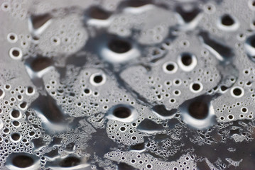 Damp macro from under the plastic material.