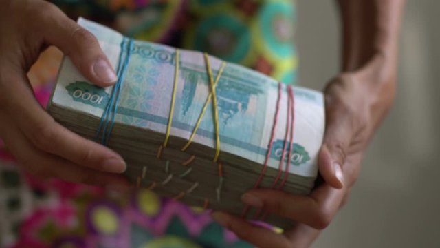 irl holds a pack of Russian money rubles