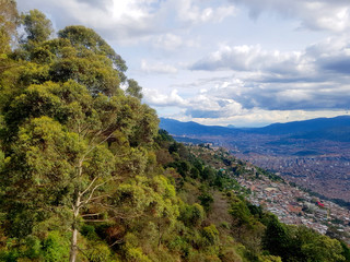 People enjoy a healthy trip in the public park Arvi in the city of Medellin, with a lot of trees, wood bridge and a river