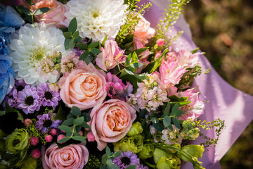 Flower background with roses, ranunculus,Pumpkin Hypericum, chrysanthemum.Spring, summer floral arrangement for birthday ,lover,friend.Elegant gift of flowers for wedding or other celebration.