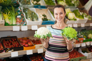 Woman choosing broccoli and cauliflower