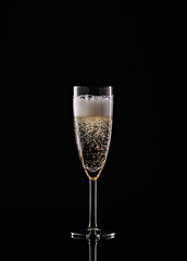 full champagne glass on black background
