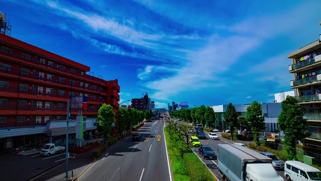 A timelapse of downtown street at Kanpachi avenue in Tokyo daytime wide shot panning