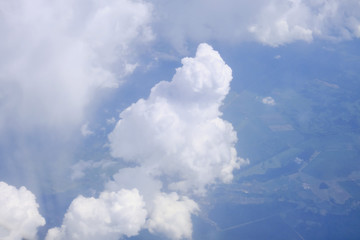Fototapeta na wymiar A big white cloud that looks like a man's penis. An object-like cloud in the blue sky.