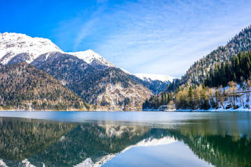 Beautiful mountains reflected in the water of the Abkhazian lake Ritsa in the Caucasus.