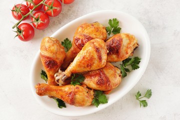 Chicken drumsticks baked in marinade with tomato sauce, soy sauce and olive oil.