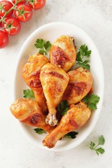 Chicken drumsticks baked in marinade with tomato sauce, soy sauce and olive oil.