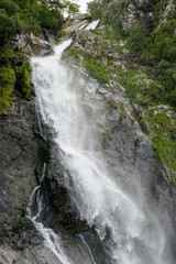 Obraz na płótnie Canvas High Waterfall on a Mountain Range