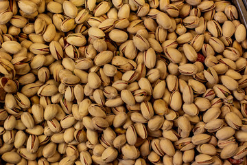 pistachios fried salted nuts textured  background food picture in supermarket counter 
