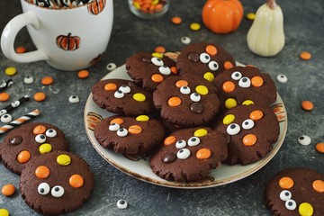 Homemade Chocolate Chip Cookies whith spooky candy eyes for Halloween Party. Halloween background. 