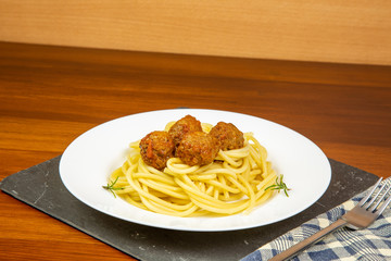 pasta and meatballs white plate