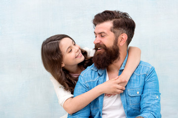 Fototapeta premium I loved her first. Bearded man and small girl child sharing love and laugh. Little daughter hugging father with love and care on grey background. Family love
