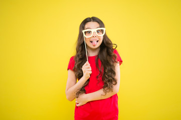 hello summer. child ready for party. prepare for party. happy girl on yellow background. summer fashion. small girl with party glasses. small girl hold funny glasses. happy birthday. party elements