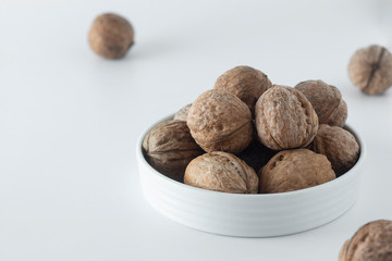 Walnut kernels, whole walnuts on white background. Healthy food for brain.