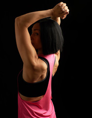 Fototapeta na wymiar girl with black hair turned her back and showing a muscular back and arms