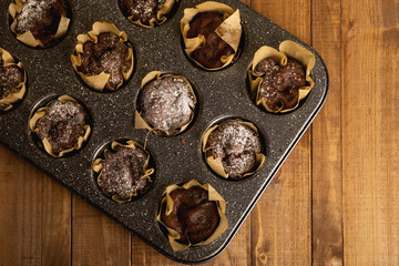 Baking tin with a tasty chocolate muffins